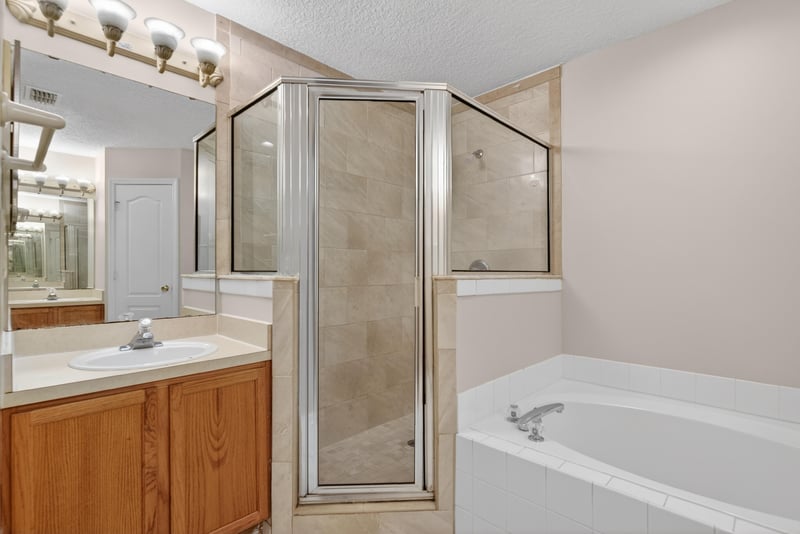 Bathroom with walk-in shower and soaking tub at 1648 Glen Laurel Dr, Middleburg, FL 32068