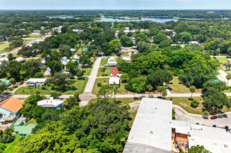 Drone view of neighborhood and lake in Crescent City, FL