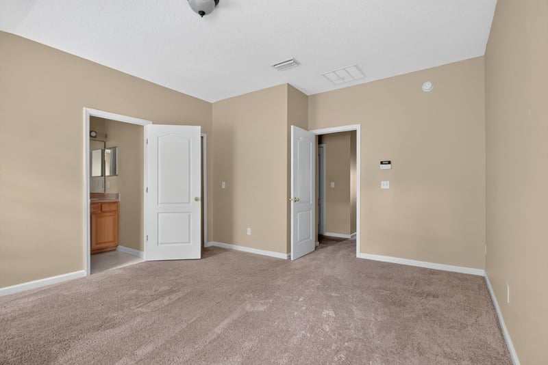 Bedroom with closet and bath doors at 12359 Mangrove Forest Ct, Jacksonville, FL 32218