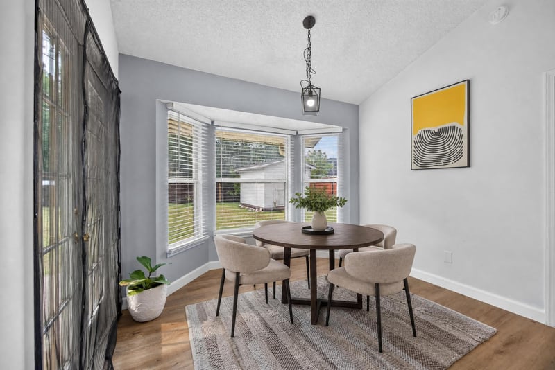 Breakfast nook with round table and bay window at 8921 Needlepoint Pl, Jacksonville, FL 32244