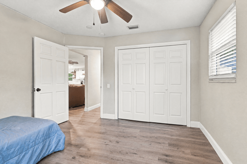 Hallway with closet doors and wood-look flooring at 357 Dillon Dr, Orange Park, FL