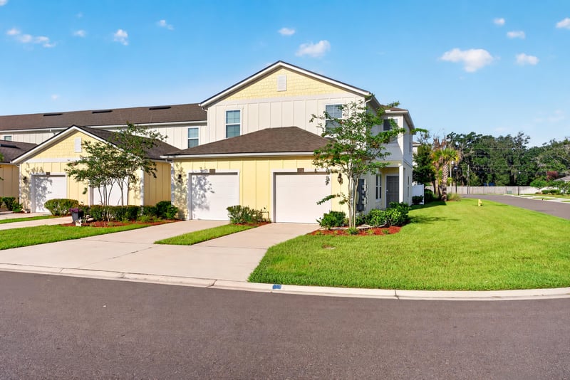 Front exterior with two-car garage and landscaped entry at 4024 Bay Hawk Ct, Jacksonville, FL