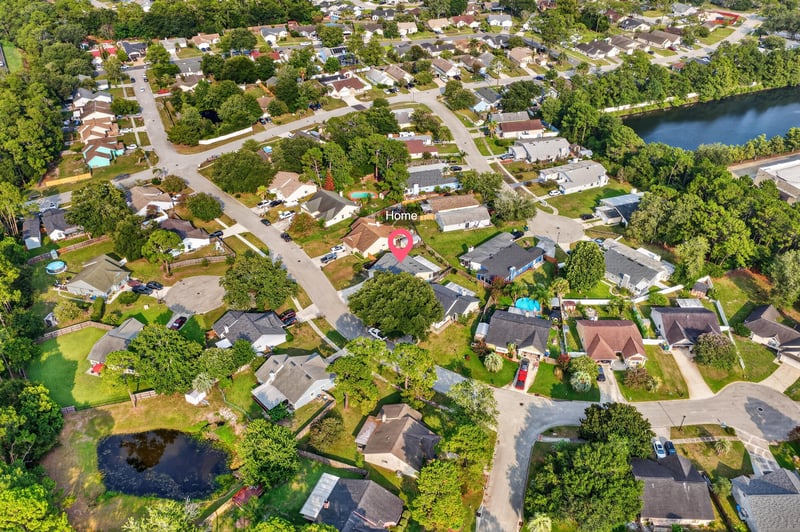 Aerial neighborhood view with streets and lake in Jacksonville, FL