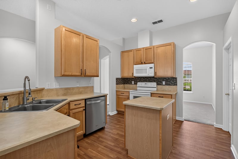 Kitchen with sink, cabinets, and granite counters at 2480 Ridge Will Dr, Jacksonville, FL 32246