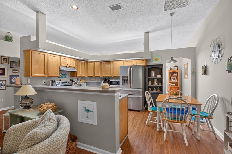 Kitchen with oak cabinets, stainless appliances and breakfast nook at 13514 Las Brisas Way N, Jacksonville, FL