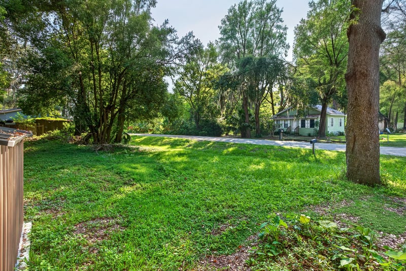 Backyard grass area with trees at 4951 Halls Dr