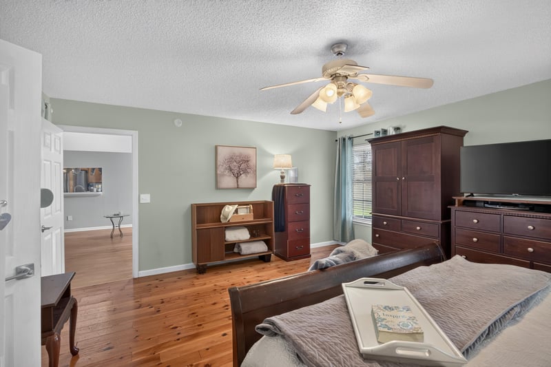 Primary bedroom with bookshelf and dresser at 4556 Shaky Leaf Ln N, Jacksonville, FL 32224