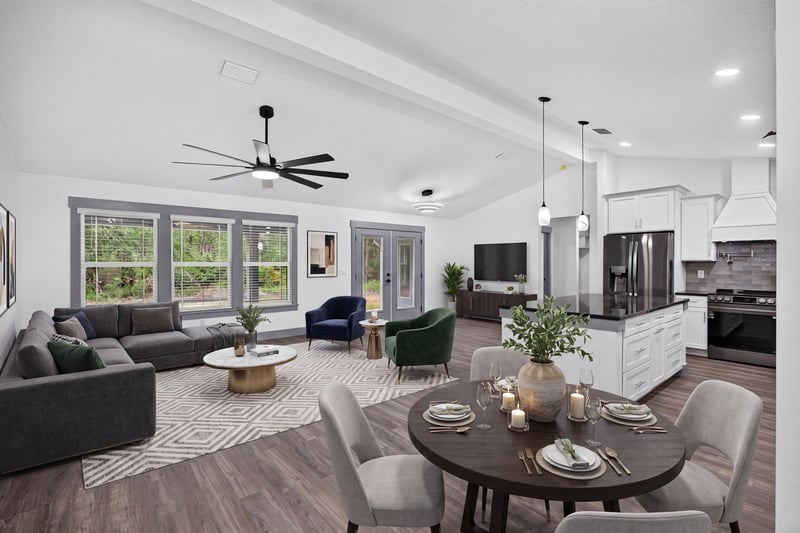 Living room open to the kitchen under a vaulted ceiling at 4800 Acacia St, Middleburg, FL 32068