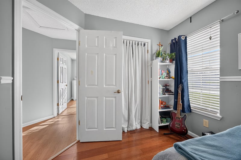 Bedroom closet doors and wood flooring at 4556 Shaky Leaf Ln N, Jacksonville, FL 32224