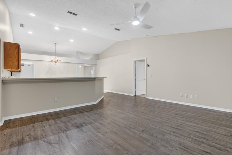 Open living and kitchen area with wood flooring at 1648 Glen Laurel Dr, Middleburg, FL 32068