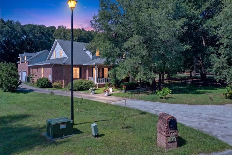 Front exterior with lamp post and driveway at day-to-dusk at 1735 Hagans Ridge Ct