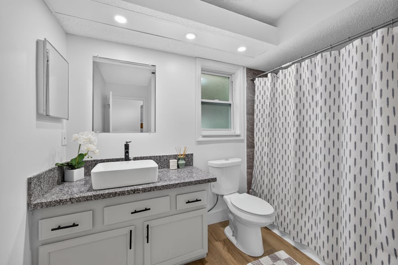 Bathroom with farmhouse sink vanity at 8921 Needlepoint Pl, Jacksonville, FL 32244