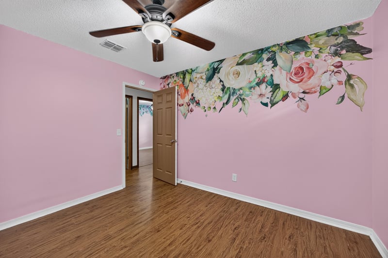 Bedroom with pink walls and painted floral mural at 892 Branscomb Rd, Green Cove Springs, FL