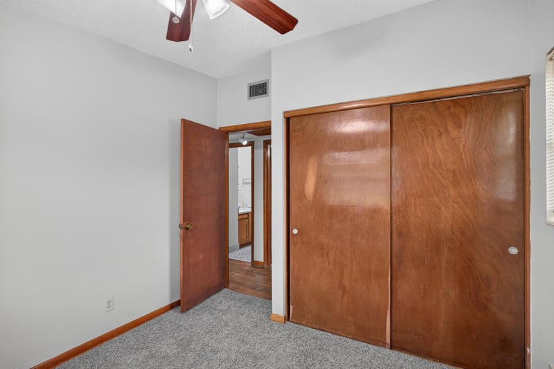 Bedroom with carpet and wood closet doors at 11462 Elane Dr, Jacksonville, FL