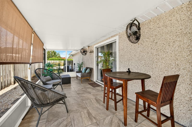 Screened porch with table and chairs at 12825 Kelsey Island Dr, Jacksonville, FL 32224
