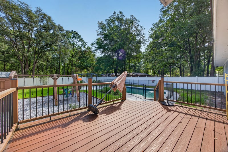 Wood deck with hammock and tree-lined yard at 892 Branscomb Rd, Green Cove Springs, FL