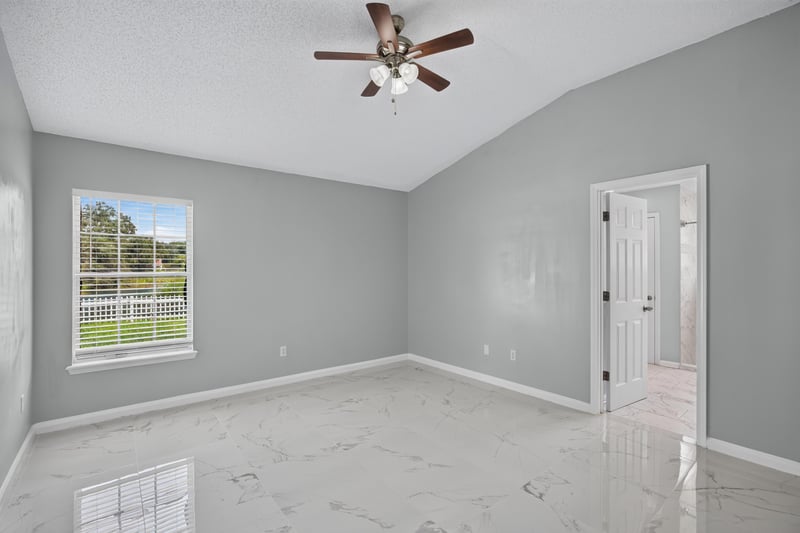 Bedroom with vaulted ceiling and window at 490 Hillside Dr, Orange Park, FL 32073