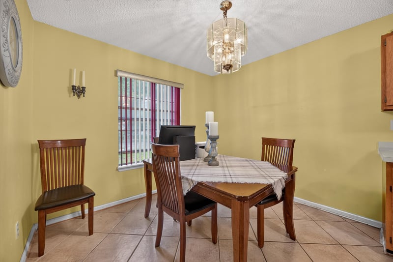 Dining room with chandelier and wood table at 5375 Dodge Rd, Jacksonville, FL 32209