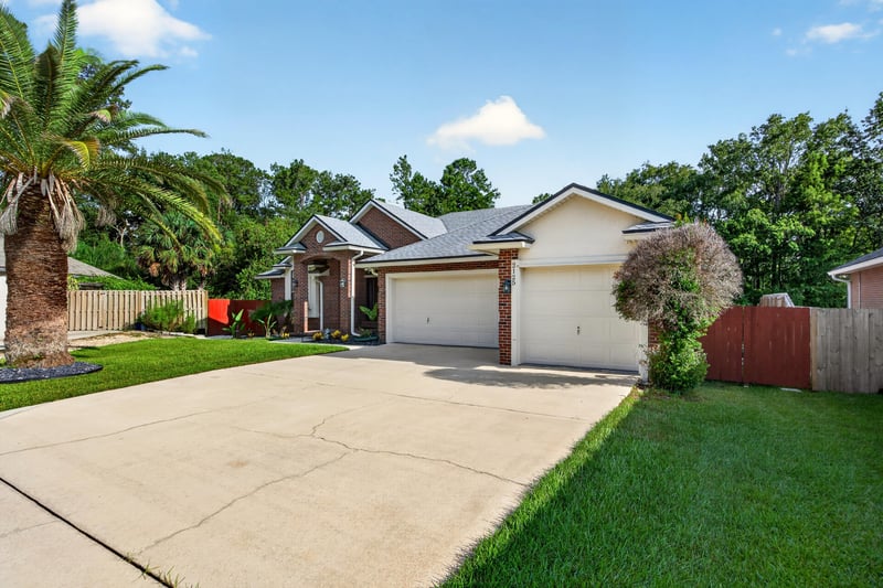Front exterior from street with long driveway at 2125 Blue Heron Cove Dr, Orange Park, FL 32003