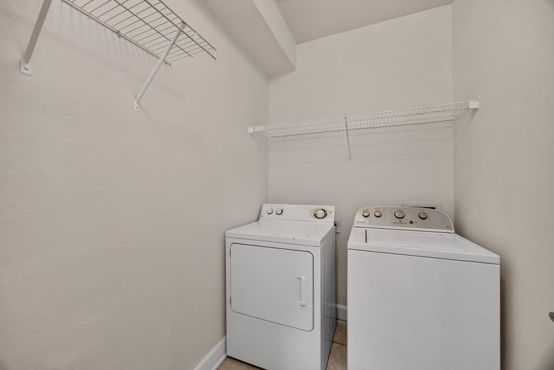 Laundry closet with hanging rod and shelf at 9745 Touchton Rd, Jacksonville, FL 32246