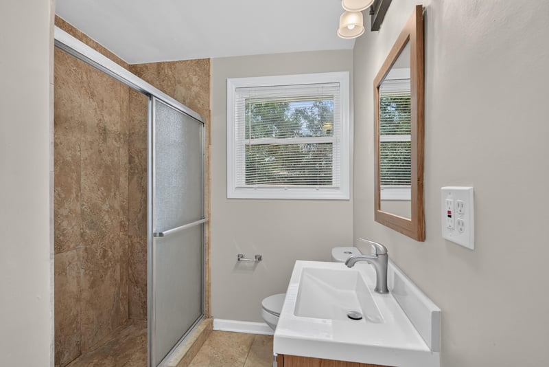 Bathroom with window and tile shower at 217 Baisden Rd, Jacksonville, FL 32218