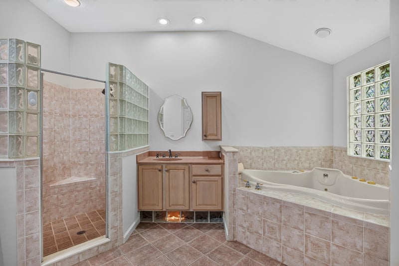 Primary bath vanity and soaking tub at 11675 Magnolia Estates Rd, Jacksonville, FL 32223