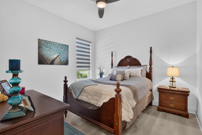 Bedroom with four-poster bed and wood nightstands at 785 Back Creek Dr, St. Augustine, FL 32092