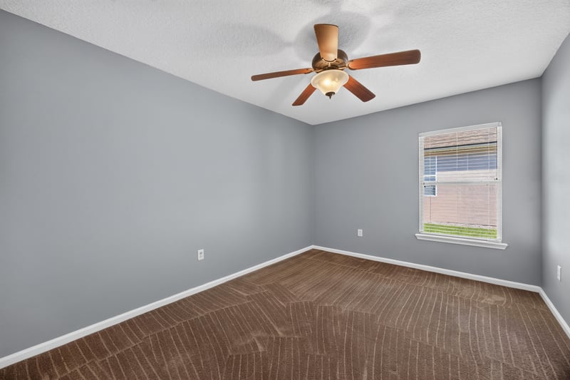 Empty bedroom with blue walls and carpet at 2282 Justin Lake Dr, Jacksonville, FL