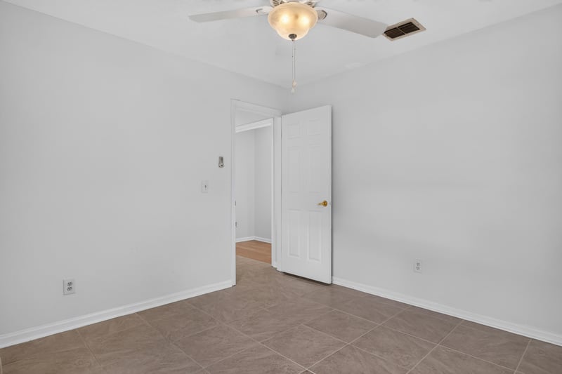 Empty bedroom with doorway at 12810 Swamp Owl Ln