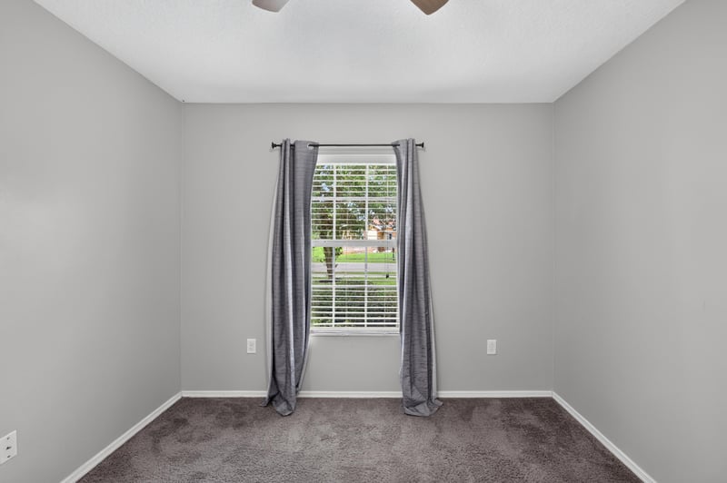 Empty bedroom with carpet and window at 7545 Lirope St, Jacksonville, FL 32244
