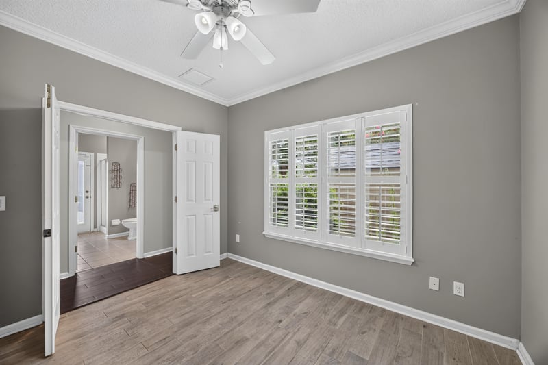 Empty room with wood-look floors and doorway at 1493 Greyfield Dr, St. Augustine, FL 32092