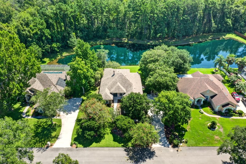 Aerial of homes lining the pond in Jacksonville, FL