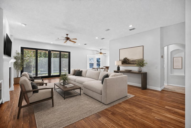 Living room staged with sofa and wood floors at 11675 Magnolia Estates Rd, Jacksonville, FL 32223