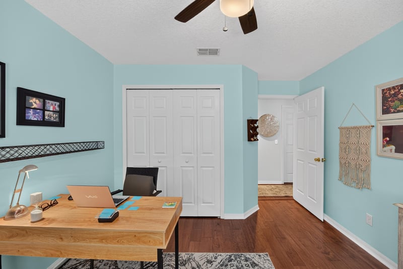 Office area with desk and closet doors at 1820 Burgess Hill Dr E, Jacksonville, FL