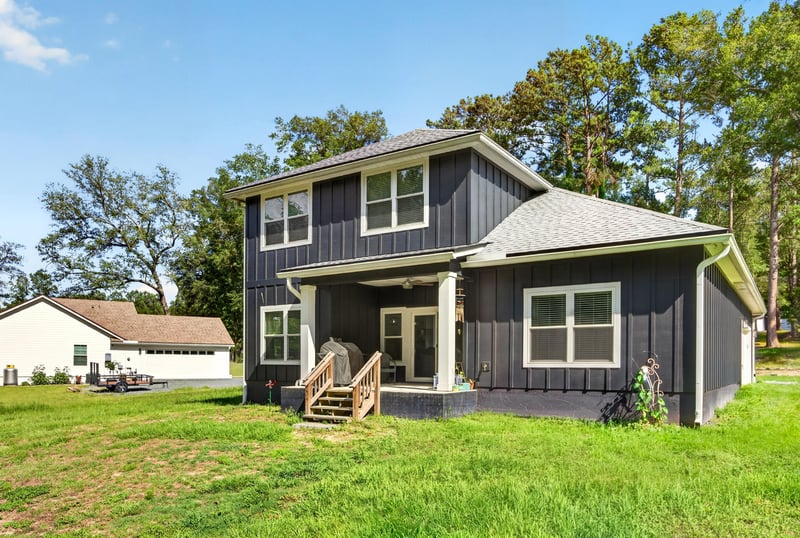Side exterior view with exterior stairs and yard at 2817 Camel Cir, Middleburg, FL