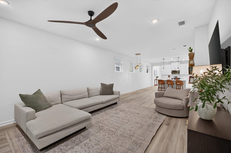 Living room with sectional sofa and ceiling fan at 93 Lochloosa Ct, St. Johns, FL 32259