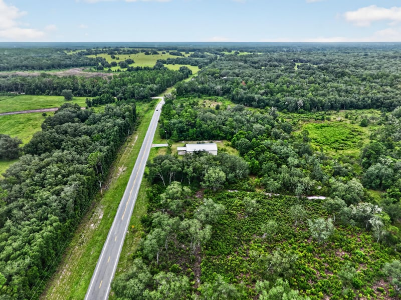 Drone aerial of the county road leading to the property at 1038 County Rd 315, Melrose