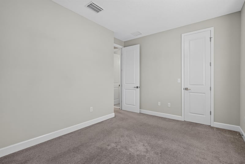 Bedroom with carpet and closet doors at 7446 Loggerhead Ct, Jacksonville, FL 32256