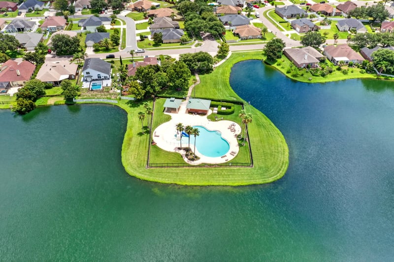 Aerial view of the community pool beside the lake in Windsor Chase