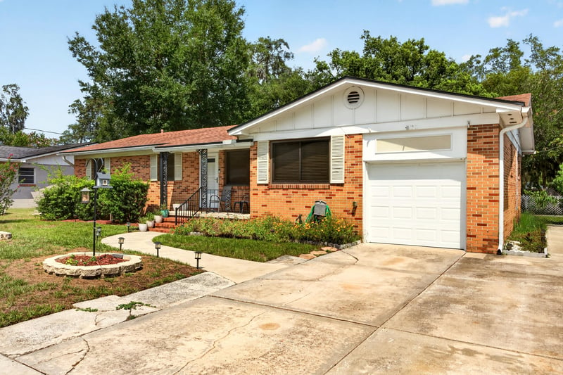 Front exterior with driveway and garage door at 1847 Grove Park Dr, Orange Park, FL
