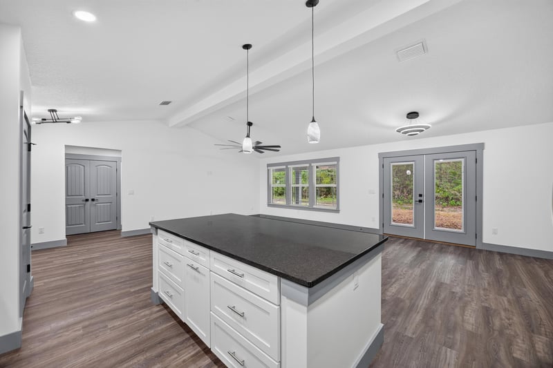 Open kitchen and living area under vaulted ceiling at 4800 Acacia St, Middleburg, FL 32068
