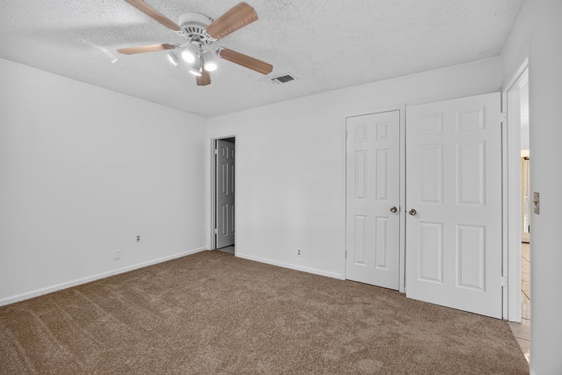 Bedroom with double closet doors and ceiling fan at 2829 Blackberry Ave
