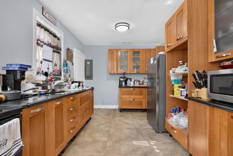 Kitchen with wood cabinets and stainless refrigerator at 5745 110th St, Jacksonville, FL 32244