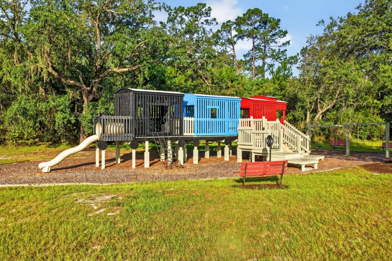 Community playground with slide and climbing structure in Green Cove Springs, FL
