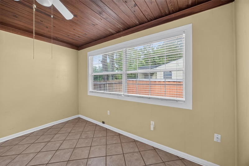 Empty room with tile floor, wood ceiling and windows at 2841 Ernest St, Jacksonville, FL 32205