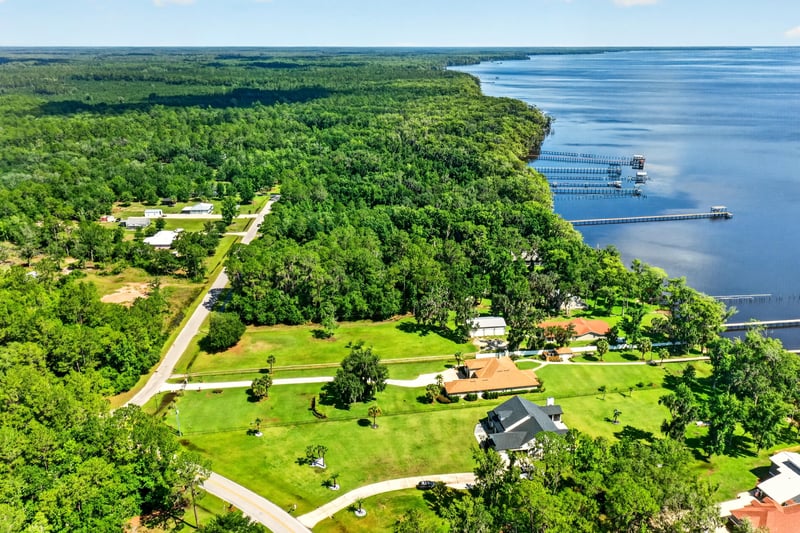 Wide aerial view of the river and a boat near the shoreline at 110 River Shores Rd, Palatka, FL 32043