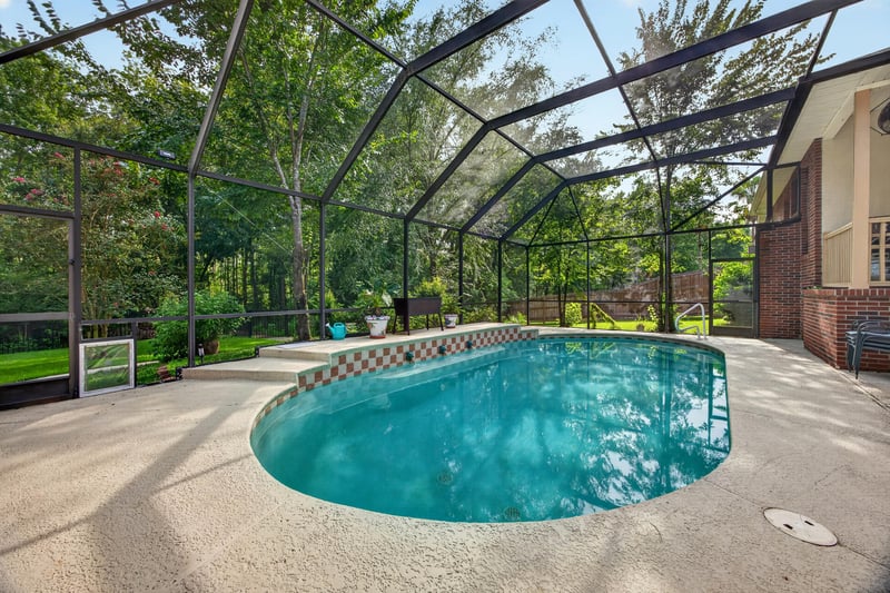 Screened pool with home in background at 2125 Blue Heron Cove Dr, Orange Park, FL 32003