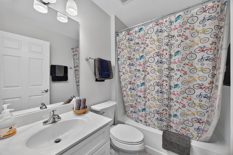 Hall bathroom with tub and shower curtain at 11225 Water Spring Cir, Jacksonville, FL 32256