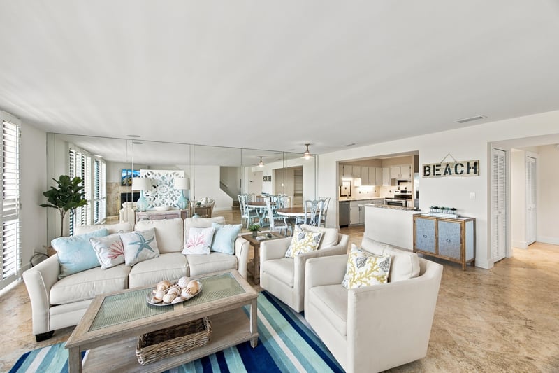 Open living, dining and kitchen area with beach decor at 752 Spinnakers Reach Dr, Ponte Vedra Beach, FL 32082