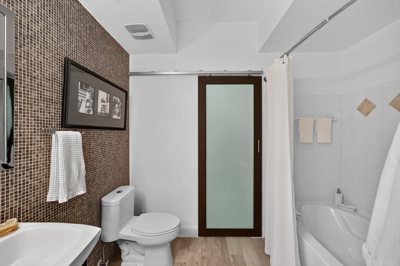 Bathroom with tile walls and glass-block shower at 10435 Mid Town Pkwy unit 135, Jacksonville, FL 32246
